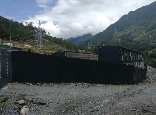 An aerial view of a mining farm showcasing rows of mining rigs and cooling systems.